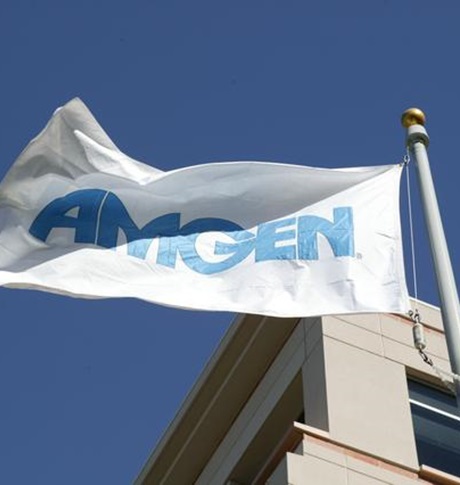 Amgen flag flying against blue sky and building